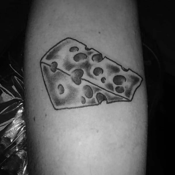 Black and gray tattoo of a wedge of Swiss cheese with detailed shading and bold outlines, creating a realistic texture on the skin.