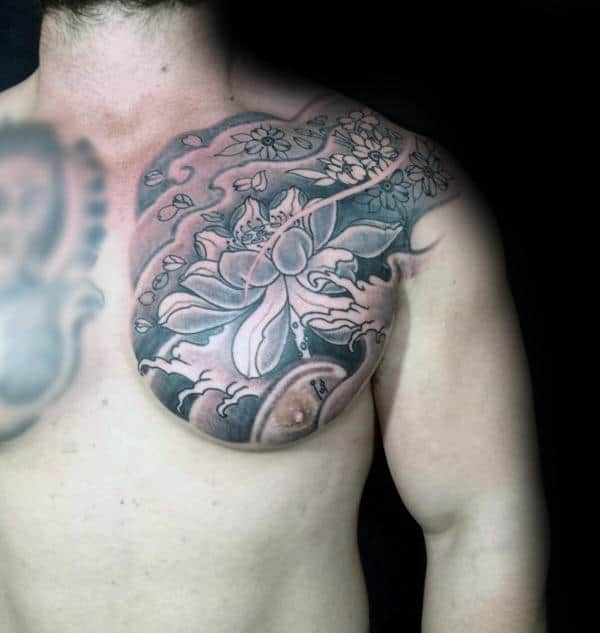 Shaded upper chest tattoo featuring a large lotus flower, swirling wind patterns, and delicate cherry blossoms in a Japanese-inspired design