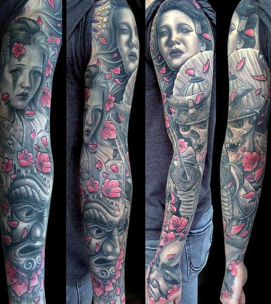 Full sleeve tattoo with portraits, pink petals, and intricate designs on an arm