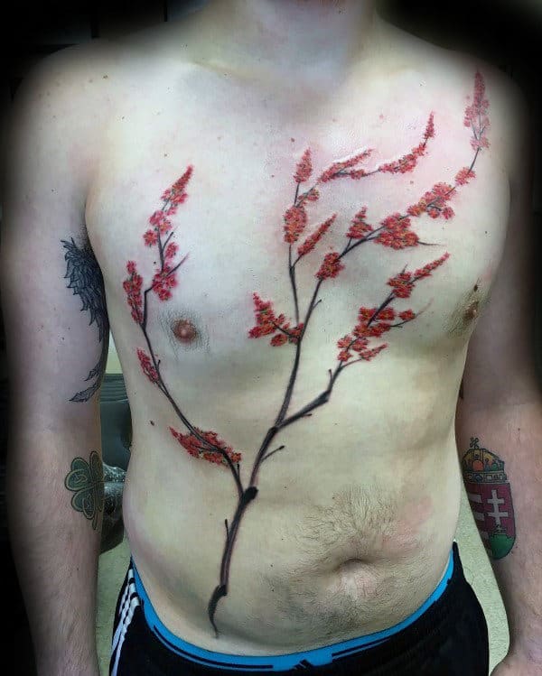 Man with a tattoo of a red cherry blossom tree branch on his chest and stomach