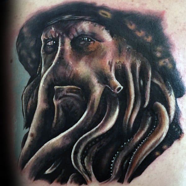 Tattoo of Davy Jones with tentacles for a beard, wearing a hat
