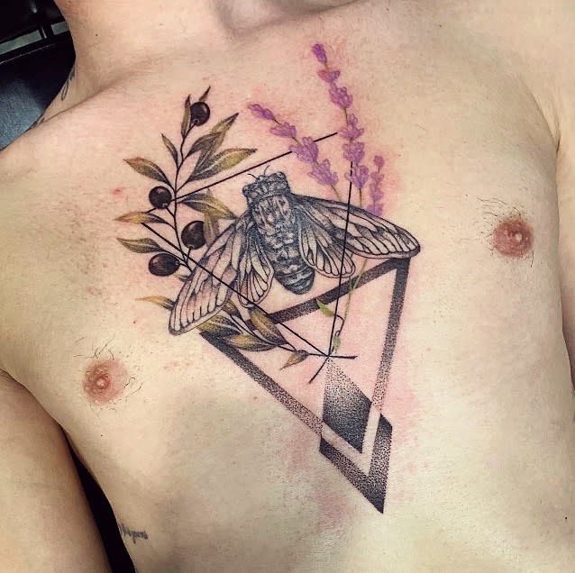 Chest tattoo of a cicada with lavender and leaves inside a geometric frame