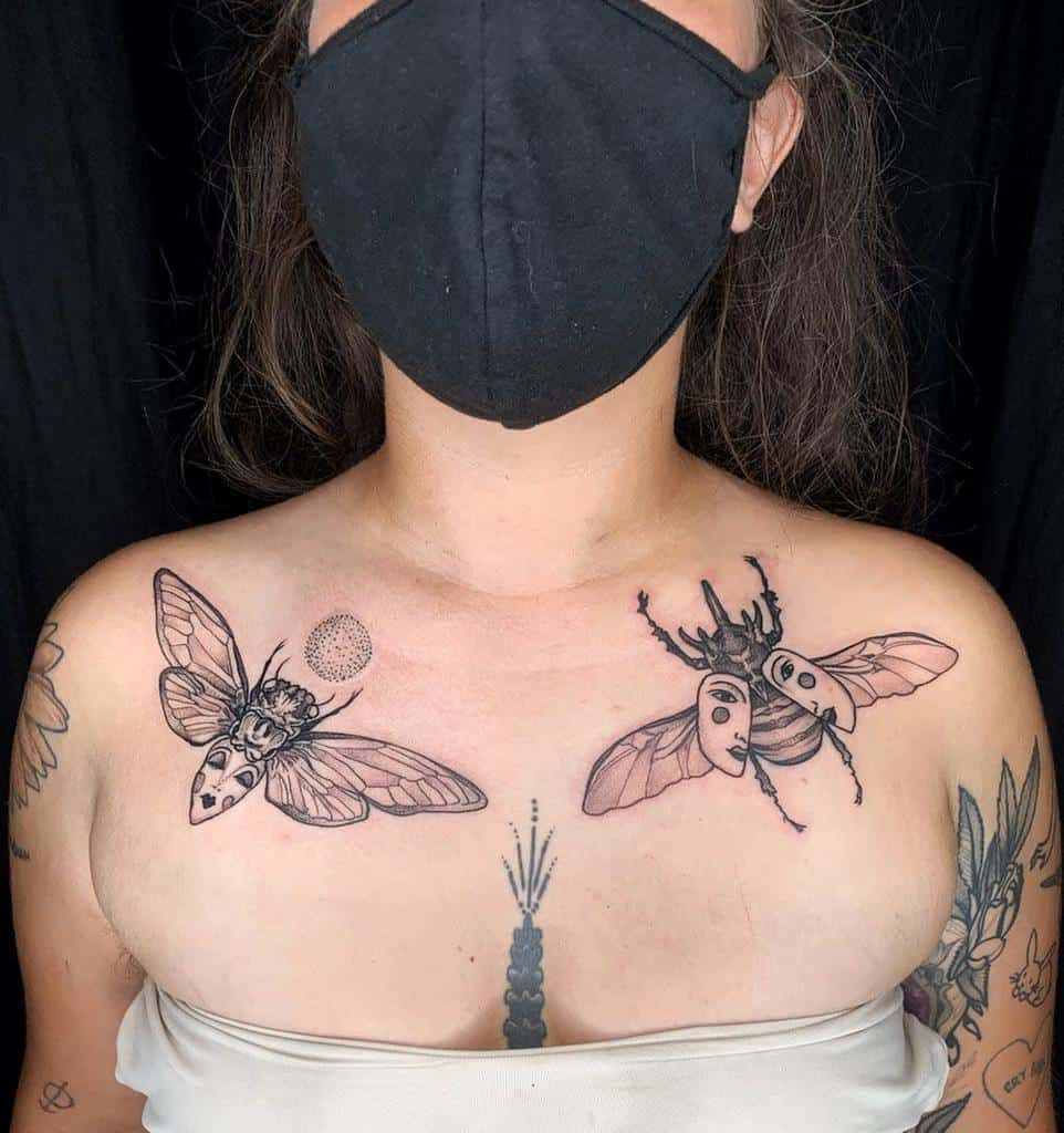 Artistic chest tattoo featuring two cicadas with intricate linework, one adorned with abstract geometric shapes and the other with surreal mask-like details