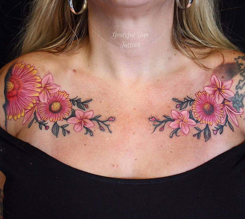Vibrant chest tattoo showcases a stunning array of pink Plumeria blossoms intertwined with Gerbera daisies, creating a balanced and radiant floral design that celebrates femininity and nature