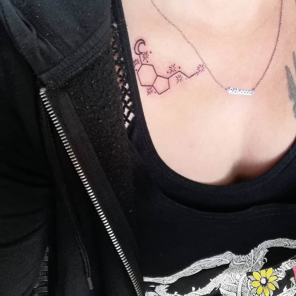 Delicate chest tattoo of serotonin molecule with crescent moon and star details