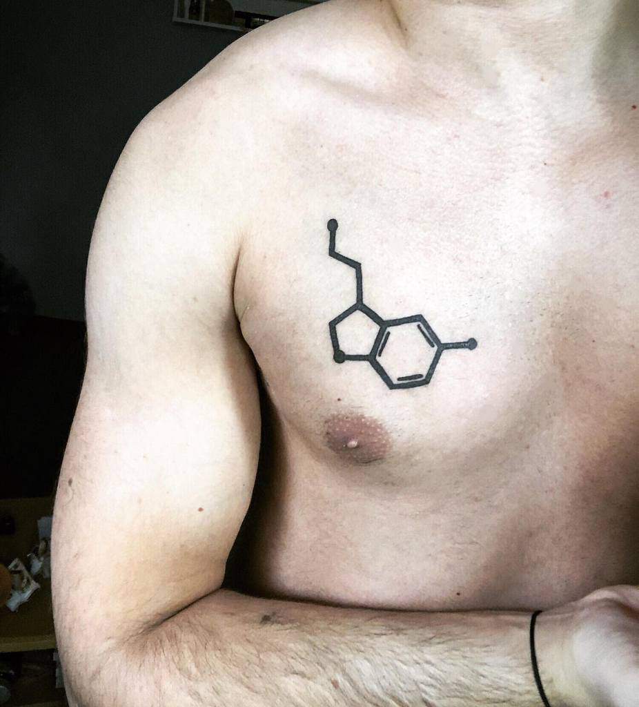 A man with a serotonin chemical structure tattoo on his chest
