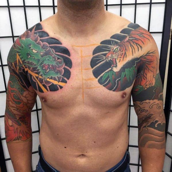 Man with dragon and tiger shoulder tattoos