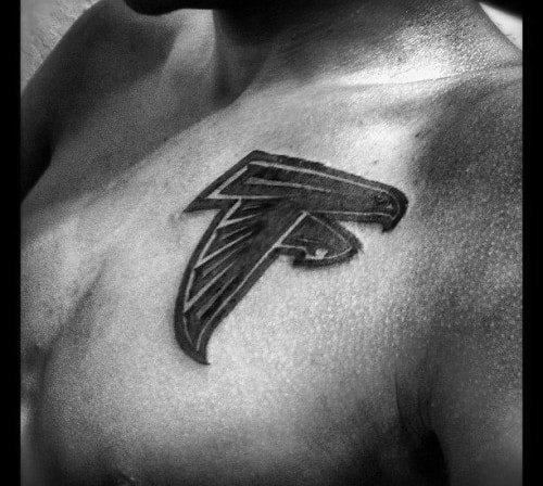Bold black Atlanta Falcons logo tattoo on the upper chest, featuring the stylized falcon in a sharp, aggressive design.
