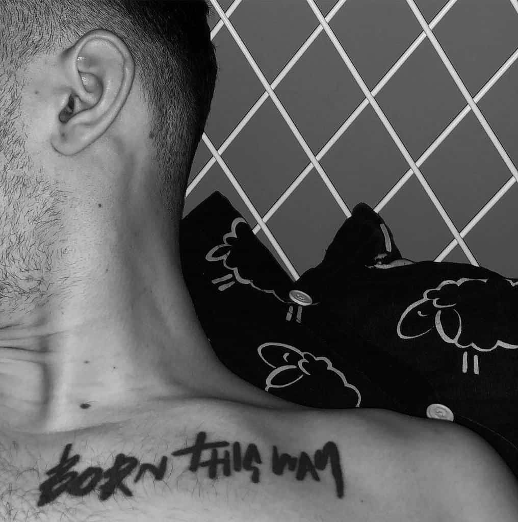 Man's shoulder with a "Born This Way" tattoo