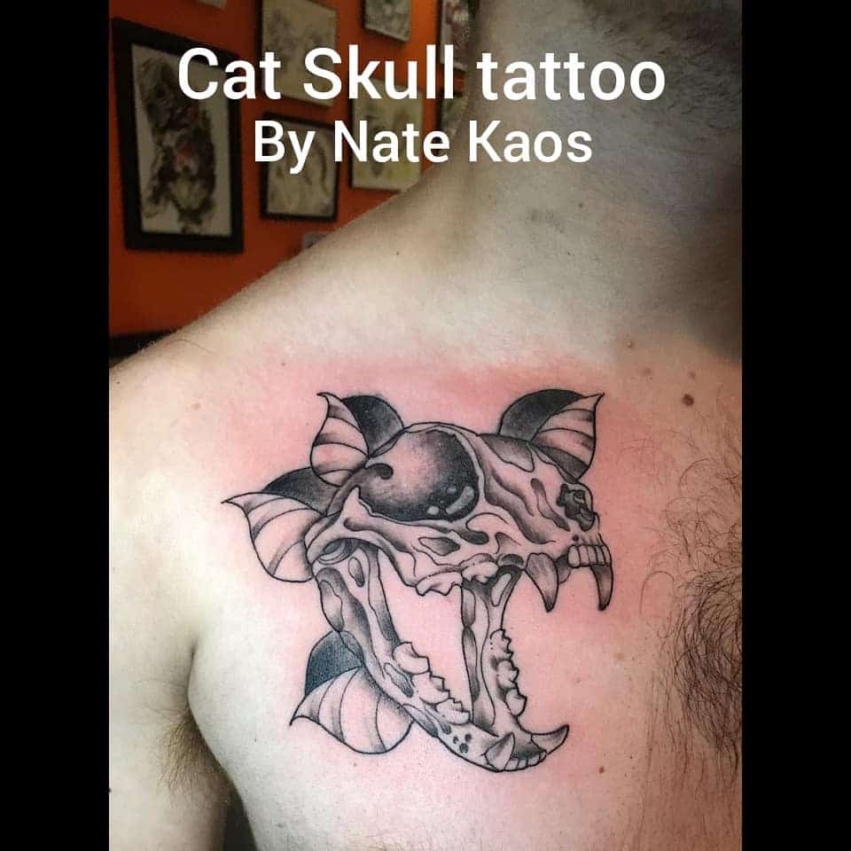 Cat skull tattoo on man's chest