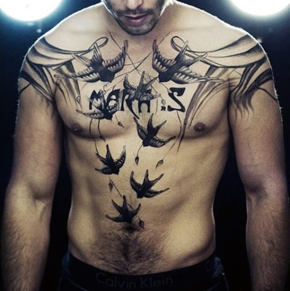 Man with bird tattoos on his chest and stomach