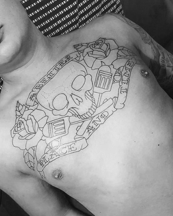 Black outline chest tattoo featuring a skull, roses, crossed pistols, and a banner reading “Another Place and Time.”
