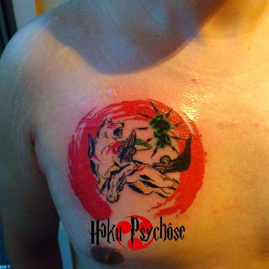 A vibrant wolf tattoo with green accents framed in red ink graces a person's chest, blending Japanese artistry