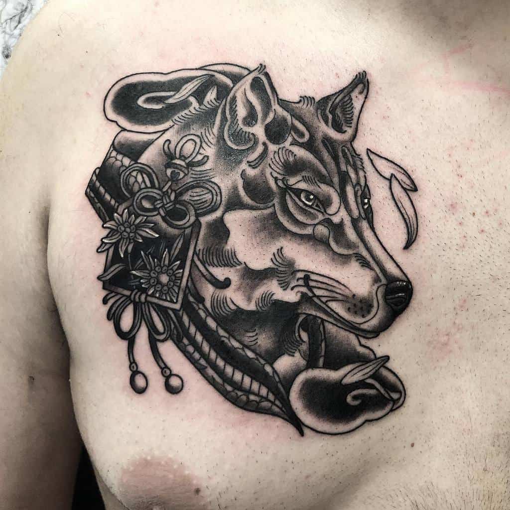 A black and gray tattoo of a wolf with intricate Japanese decorative elements graces a person's chest