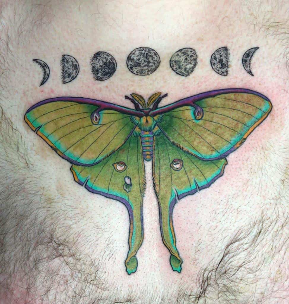 A vibrant tattoo of a Luna Moth with colorful wings, placed below a series of moon phases