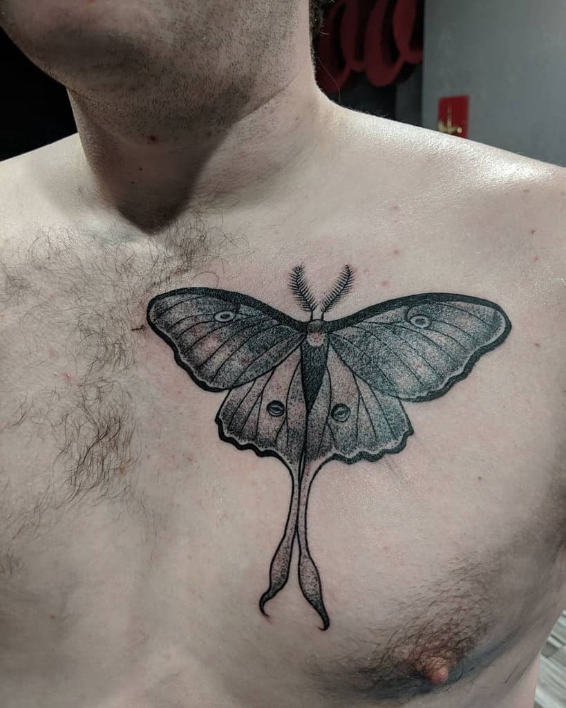 A black and grey tattoo of a Luna Moth, featuring detailed wing patterns and shading