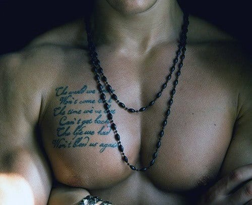 Close-up of a person's chest with text tattoo