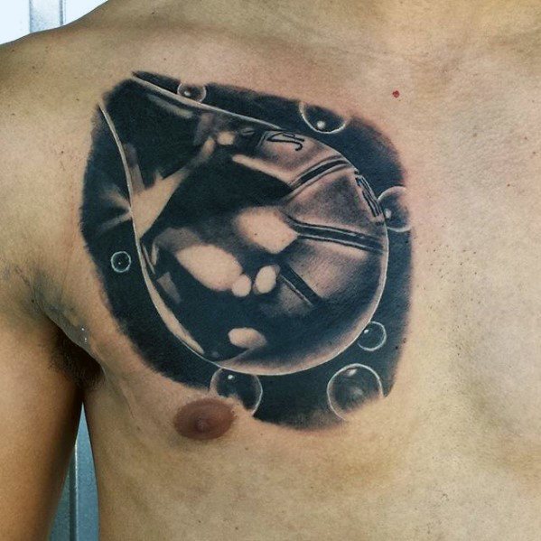 Hyper-realistic black and grey chest tattoo of a baseball inside a water droplet, surrounded by splash effects and detailed reflections.
