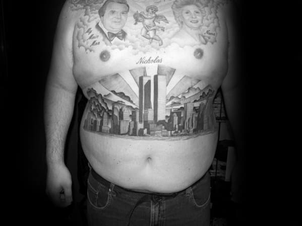Full chest and stomach tattoo featuring the Twin Towers rising above the New York City skyline, with portraits and angel imagery above.