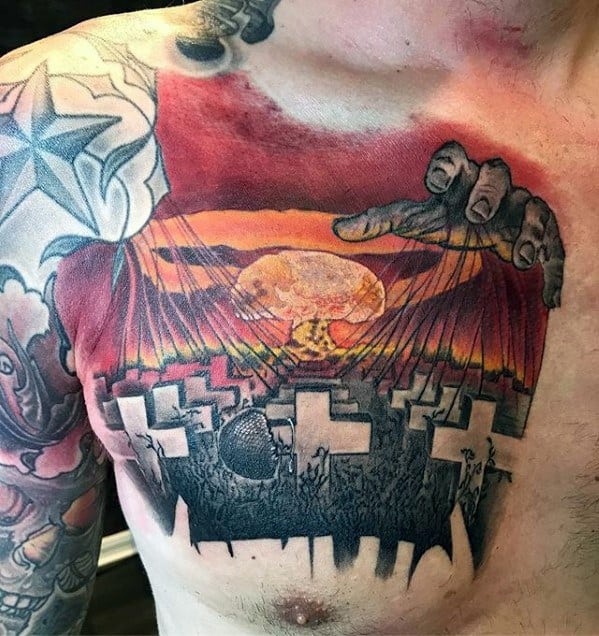 Vibrant chest tattoo of Metallica’s Master of Puppets scene with graveyard crosses, puppet strings, nuclear explosion, and shadowy hands controlling the sky.