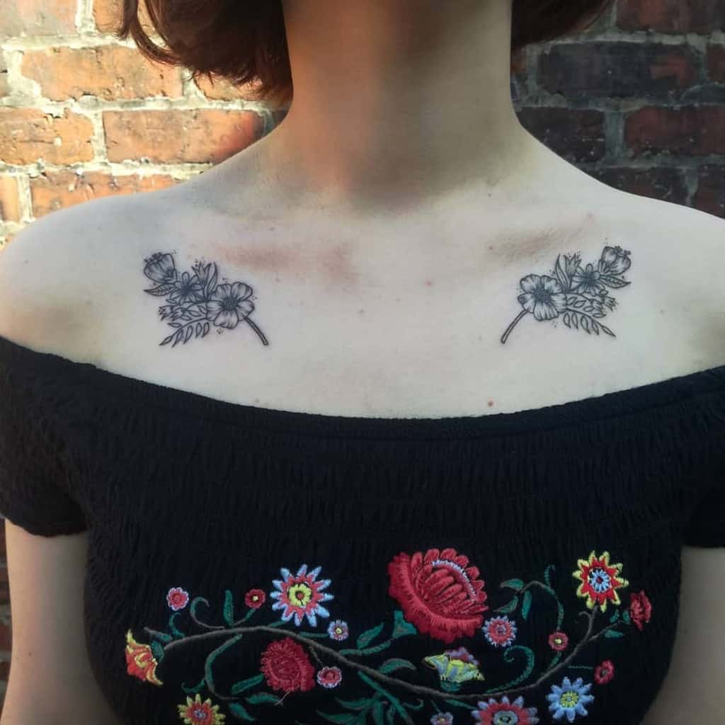 Woman with two floral tattoos on her collarbone