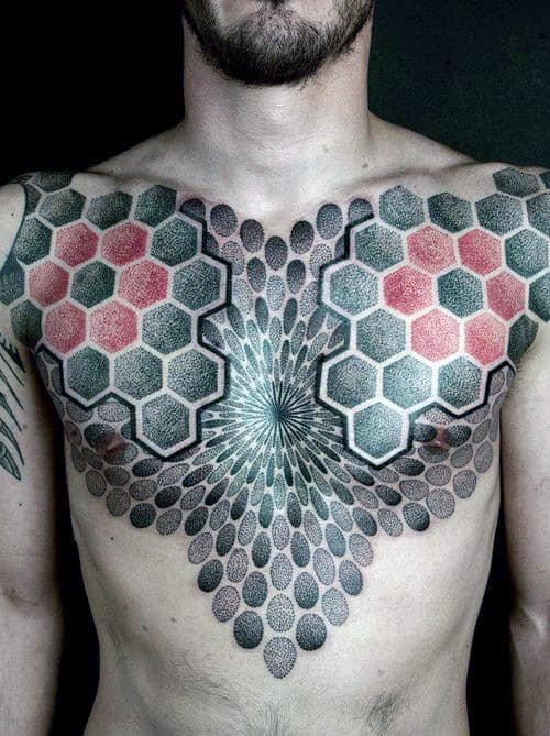 Man with geometric hexagon and dot pattern tattoos covering his chest and upper arms