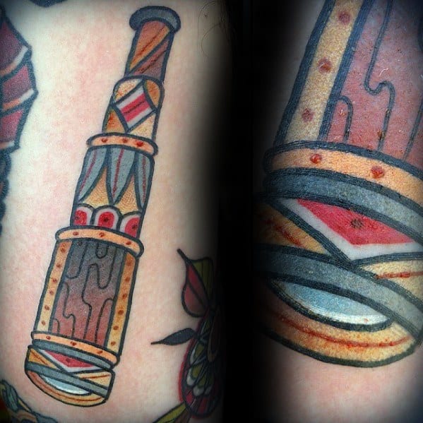 Colorful tattoo of an abstract telescope on skin