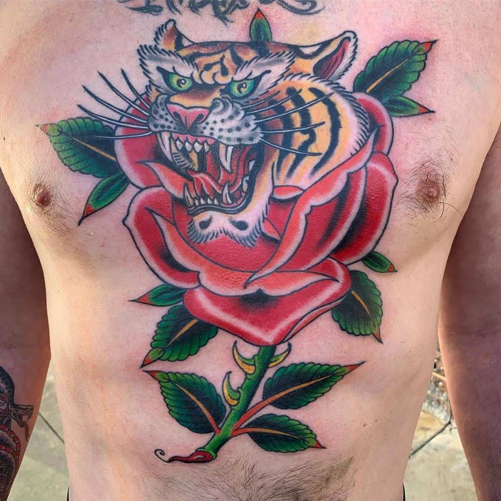 A tattoo of a fierce tiger within a rose on a man's chest