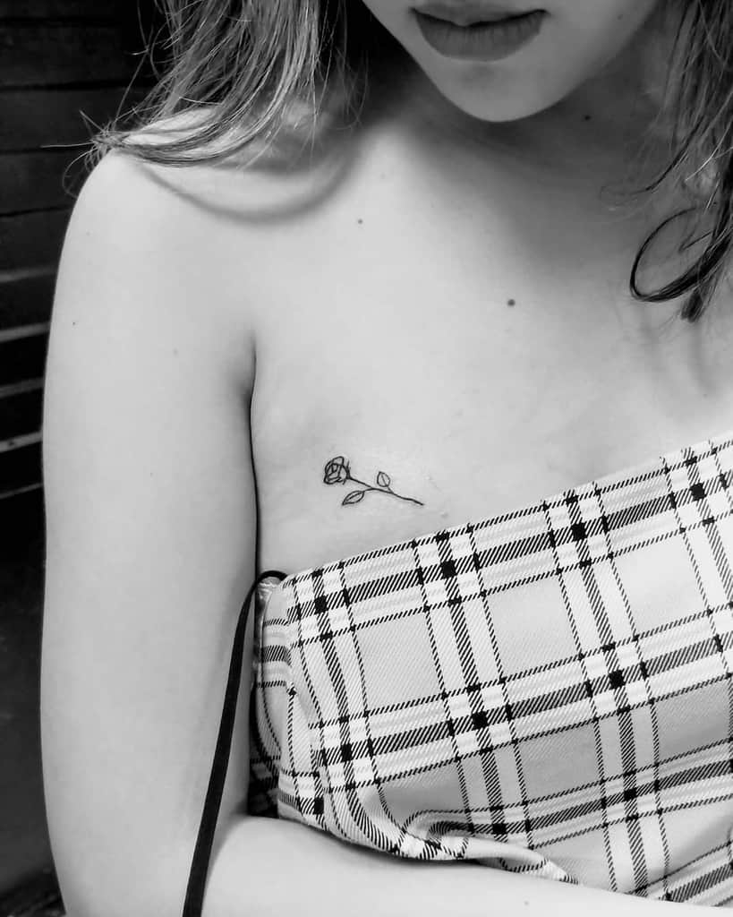 A woman with a small rose tattoo on her chest