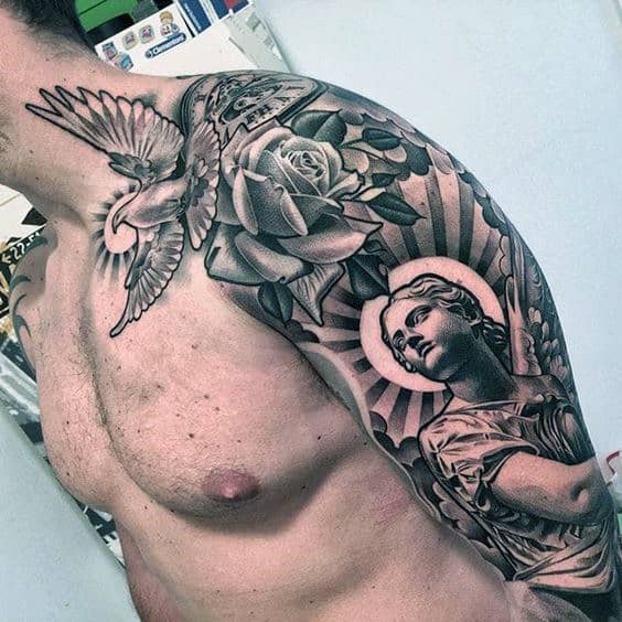 Man with a detailed shoulder tattoo of a dove, rose, and angelic figure