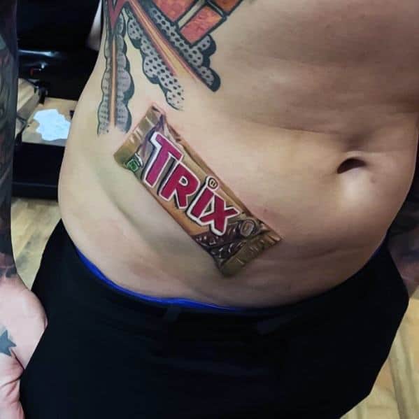 Realistic tattoo of a Trix chocolate bar on the lower abdomen, designed with detailed shading and highlights to create a 3D effect.