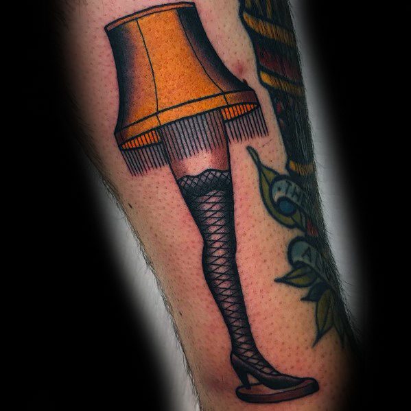 Christmas tattoo of the iconic leg lamp from *A Christmas Story*, featuring a fishnet stocking and fringed lampshade for a nostalgic holiday design.