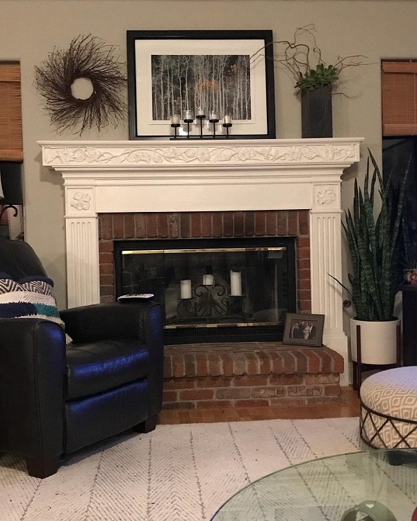 brick fireplace with coffered white mantel