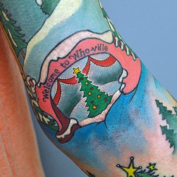 Colorful Whoville Christmas tree tattoo with festive decorations, vibrant shading, and a playful "Welcome to Whoville" banner in a whimsical style.