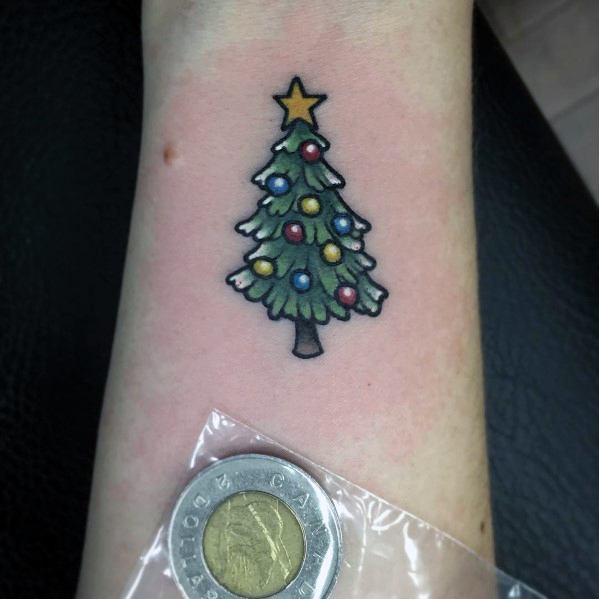 Small Christmas tree tattoo with colorful ornaments, a golden star on top, and bold outlines, creating a classic and festive holiday design.