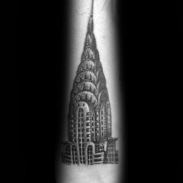 Realistic black-and-grey Chrysler Building tattoo with fine details and shading, creating a bold architectural statement.