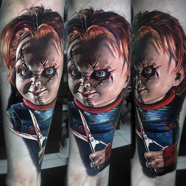 Realistic Chucky tattoo with intense shading, showing his menacing stare and stitched face while holding scissors for a dark horror effect.