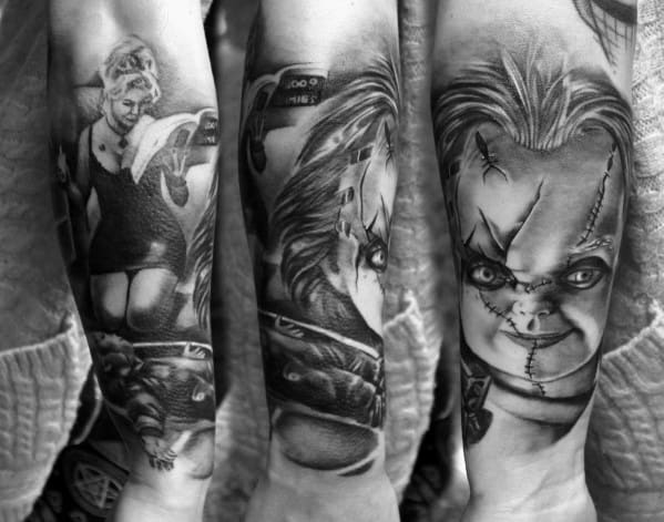 Black and grey Chucky tattoo sleeve featuring detailed horror scenes, including his stitched face, intense stare, and a dramatic action sequence.
