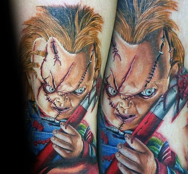 Realistic Chucky tattoo with intense blue eyes, stitched face, and a bloodied axe, capturing his menacing expression in vivid detail.