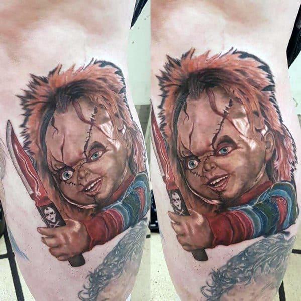 Realistic Chucky tattoo with lifelike details, featuring his sinister grin, stitched face, and a bloodied knife for a bold horror-themed design.
