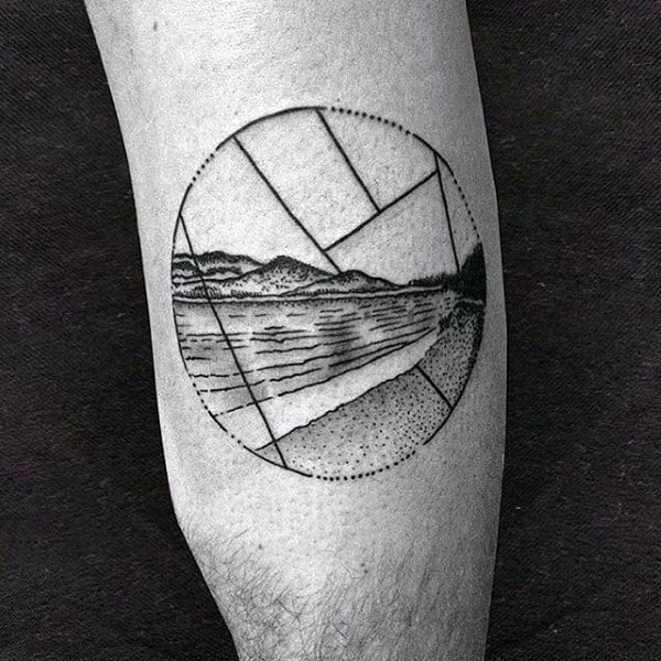 Geometric tattoo of a landscape with mountains and water inside a circle on an arm