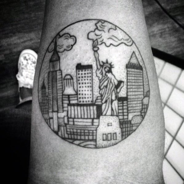 Black ink tattoo of the New York City skyline inside a circle, with the Statue of Liberty and stylized buildings in a dotted design.