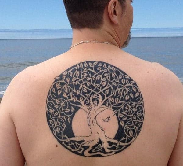 Man with a large tree tattoo on his back
