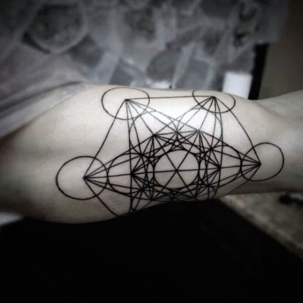 Geometric tattoo of interconnected circles and lines on an inner arm