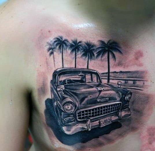Tattoo of a vintage car with a "CUBA 56" license plate on a chest, with palm trees in the background