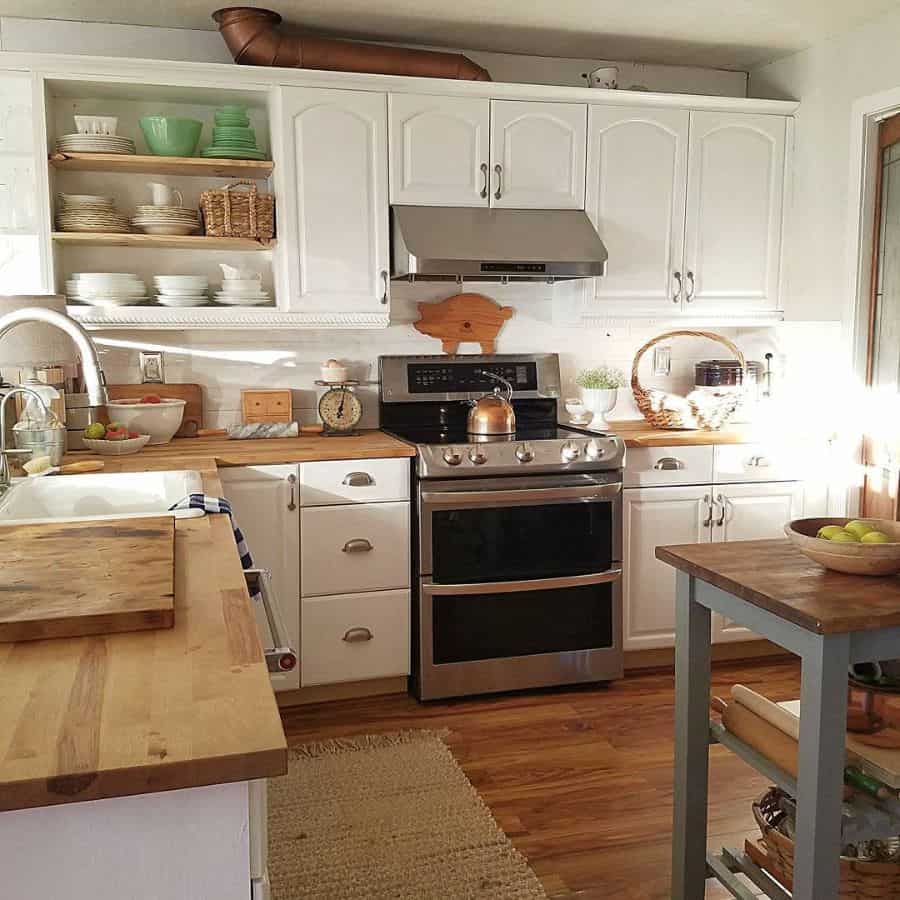 classic farmhouse kitchen wood bench hardwood floors white cabinets 