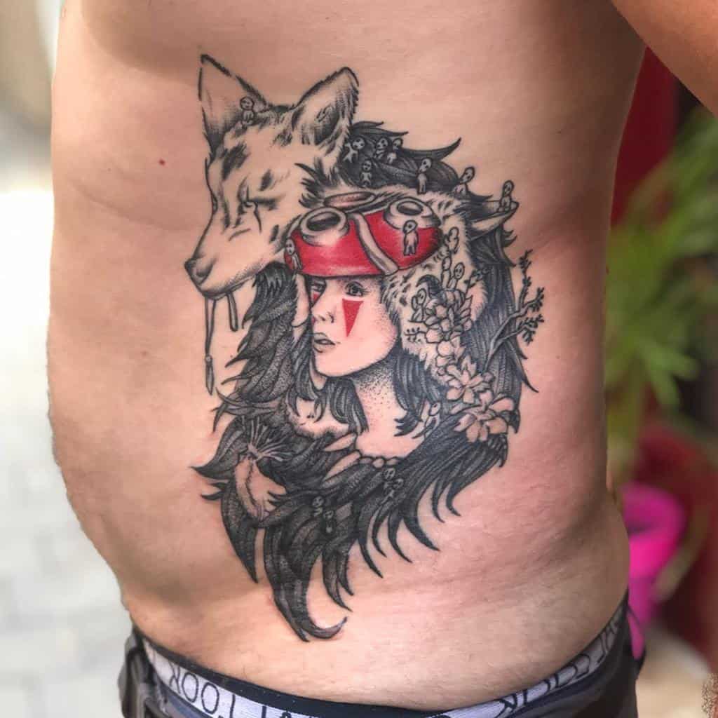Black and red tattoo of San wearing her wolf pelt, with Moro resting above, surrounded by flowers and tiny kodama spirits.