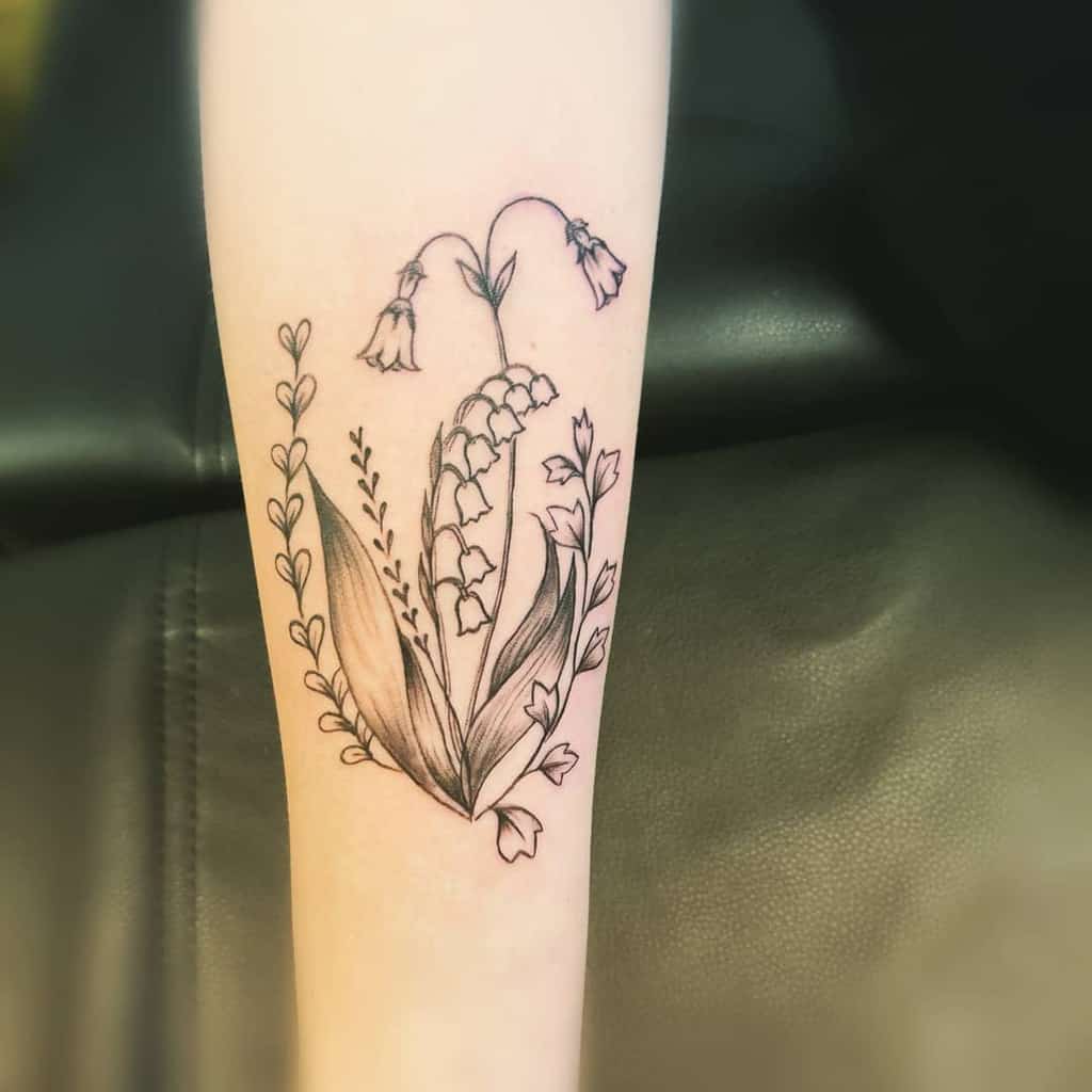 Elegant fine-line floral tattoo, featuring Lily of the Valley and other delicate flowers with soft shading and intricate details
