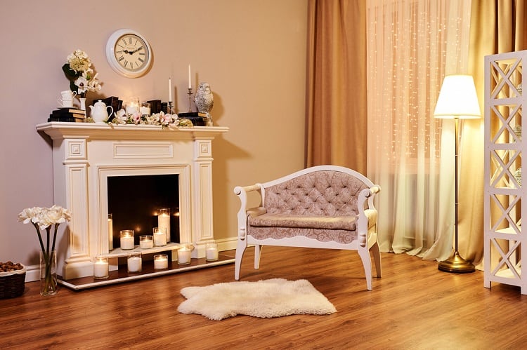 classic white ornate fireplace with candles