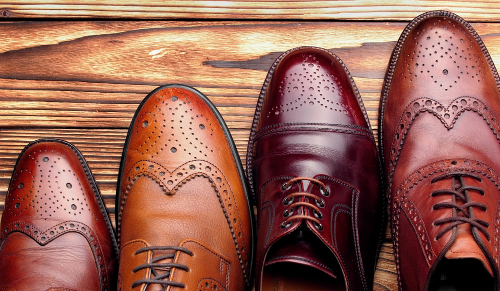 Four different men's brogue shoes in various colors
